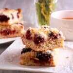 Easy and healthy blackberry pie crumble bars recipe on a white plate with tea.