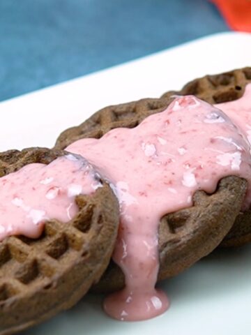 Paleo and gluten free chocolate waffle dippers recipe topped with strawberry dipping sauce.