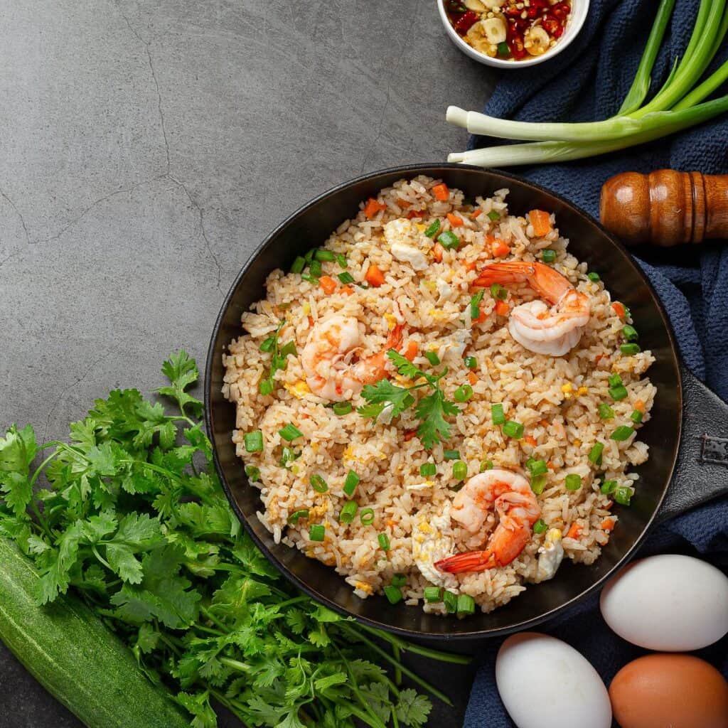 Healthy shrimp fried rice served with fresh parsley.