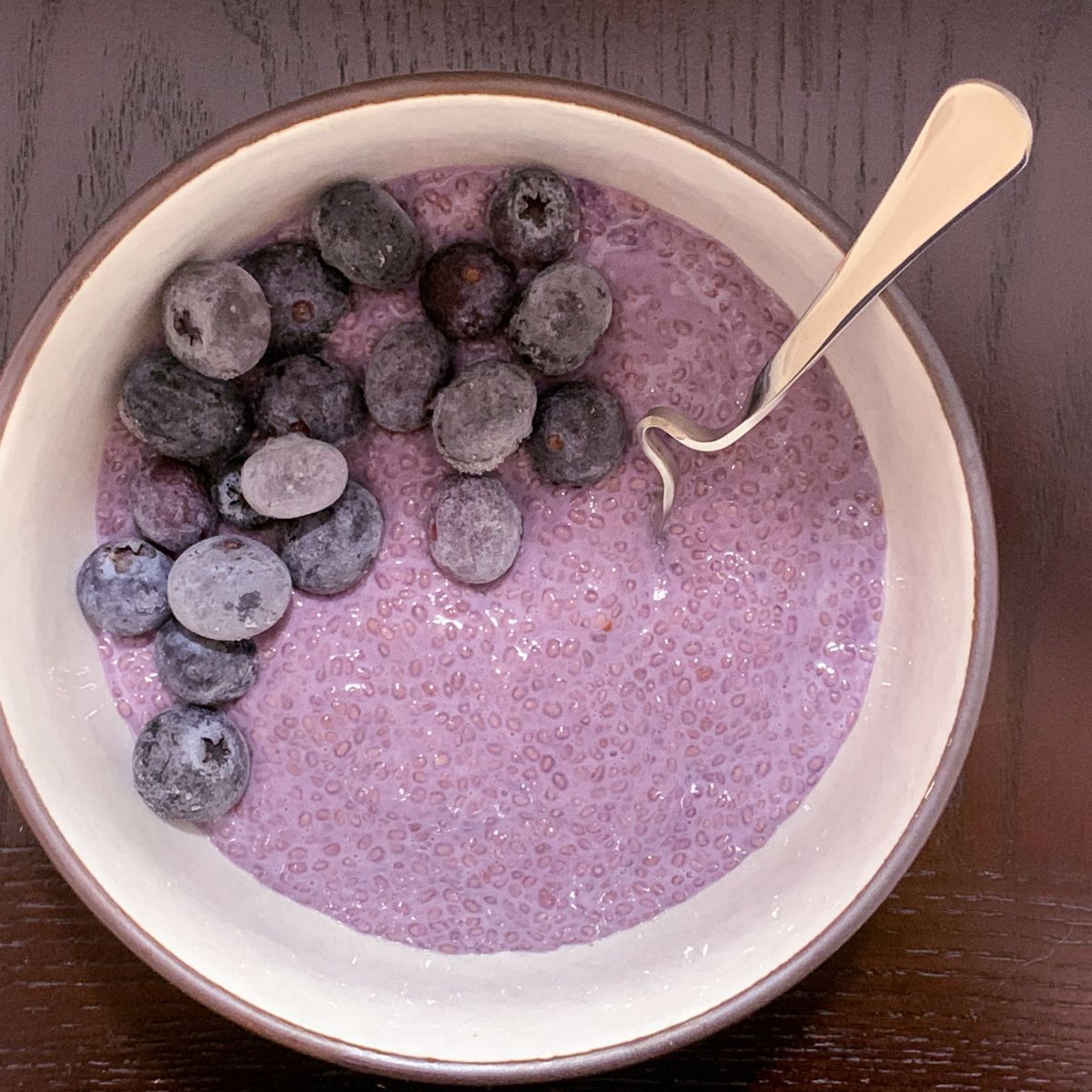 Purple sweet potato chia pudding served with fresh blueberries.