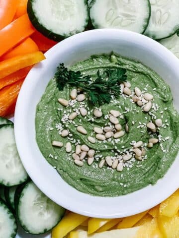 Simple and good green goddess hummus recipe served with fresh vegetables.