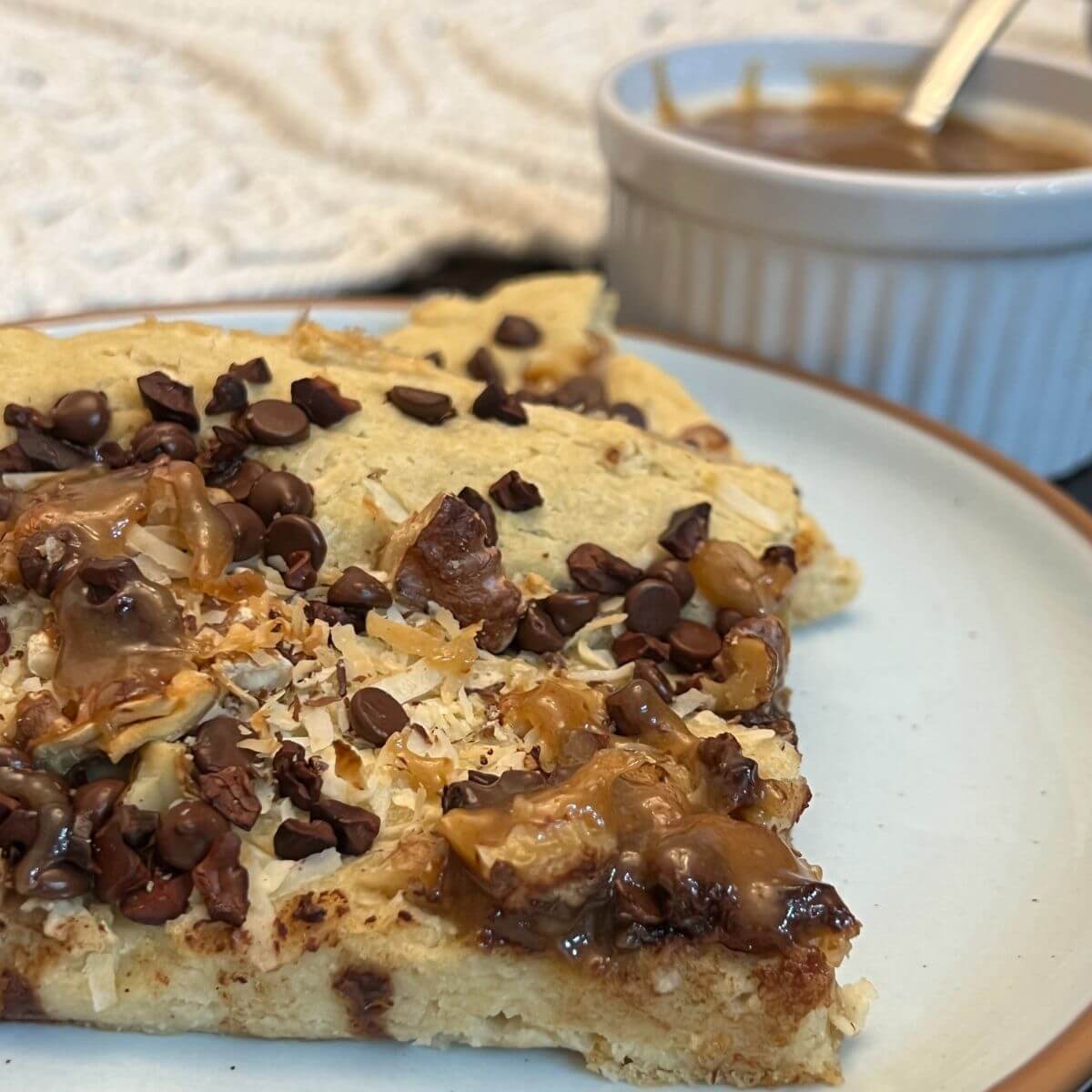 Serve magic cookie bar pancakes with prepared vegan, dairy-free caramel sauce.