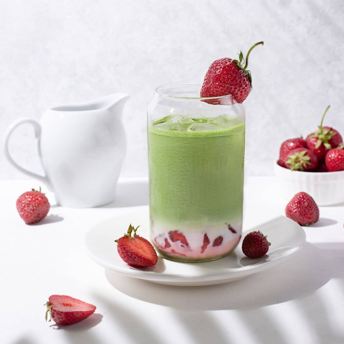 iced matcha green tea with strawberry puree and coconut milk